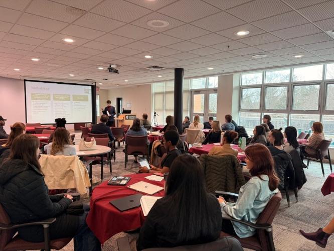 The crowd seated around tables for the 2026 honours thesis presentations