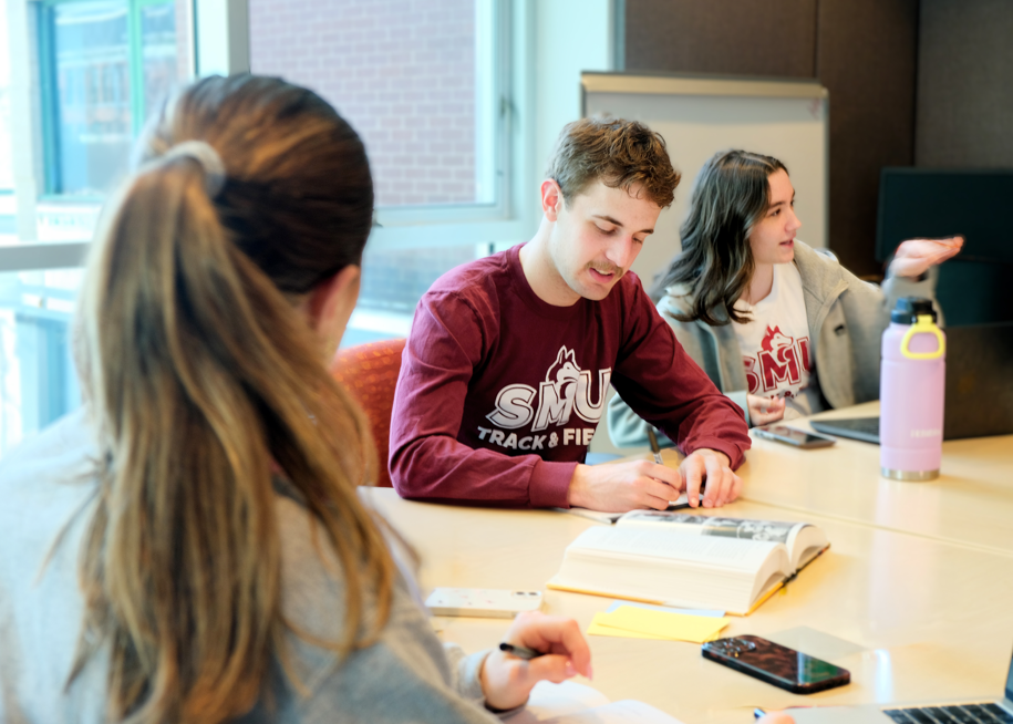 Students discussing a book